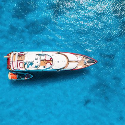 Aerial view of beautiful luxury yacht and boat in blue sea